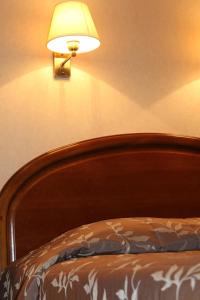サン・ジャン・ド・リュズにあるHotel Bel Airのベッドルーム1室(壁にランプ付)