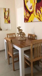 a wooden table with chairs and a statue on top of it at Hermoso depto, a pasos de todo. in Corrientes