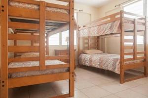 a bedroom with two bunk beds in a house at Colinas del Atlantico Vacational House 1st floor in Isabela
