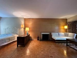 a living room with two beds and a couch at Character house in North Dunbar in Vancouver