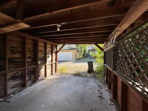 an empty garage with a wooden fence and a driveway at Character house in North Dunbar in Vancouver