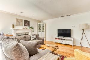 a living room with a couch and a tv at Raleigh Hills Retreat in Portland