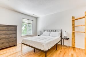 a white bedroom with a bed and a dresser at Raleigh Hills Retreat in Portland