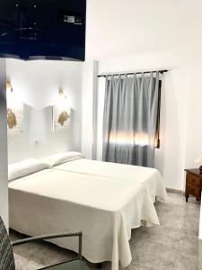Posteľ alebo postele v izbe v ubytovaní Hostal Casa López