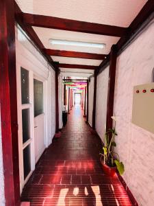 a long hallway with a red brick walkway with a rainbow at HOSTAL 469 in La Serena