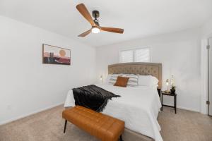 a bedroom with a bed with a ceiling fan at Beautiful 6 bed 3 bath home in quiet neighborhood in Wichita