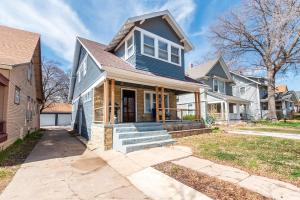 a blue house with a porch and stairs at 3 Bed 2 Bath by College Hill w Fitness Room in Wichita