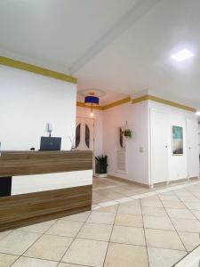 a large room with a lobby with a counter at Blue Hale in Guarujá +78 photos