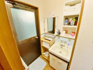 een kleine badkamer met een wastafel en een douche bij Reynaville 4F / Vacation STAY 3339 in Tokushima