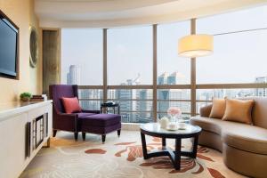 a living room with a couch and a table at Guangzhou Marriott Hotel Tianhe in Guangzhou