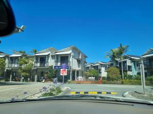 a car driving down a street with houses at Studio Apartment Noosa Riverfront in Tewantin +10 photos