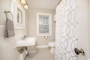 a white bathroom with a sink and a toilet at 3 Bed 1 5 Bath Home By College Hill & Hospitals in Wichita