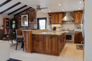 a large kitchen with wooden cabinets and a large island at Stunning Home & Spectacular View in La Mesa