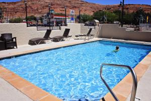 a person swimming in a large swimming pool at Bowen Motel in Moab