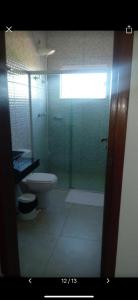 y baño con ducha de cristal y aseo. en Hotel Cruzeiro de São José, en São Francisco de Goiás