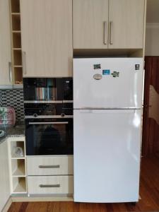 a kitchen with a white refrigerator and a stove at Özçelik apartmanı in Alanya