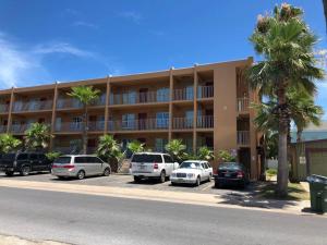 a large building with cars parked in a parking lot at 2 Bed 2 Bath 1st Fl Condo By Beach w Washer Dryer in South Padre Island