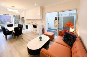 a living room with a couch and a table at Churchill’s Rest in Sydney