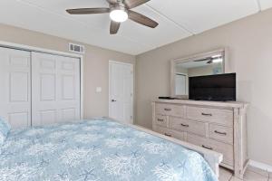 a bedroom with a bed and a flat screen tv at 2 Bed 1 Bath Condo By Beach & Entertainment in South Padre Island