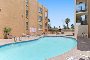 a large swimming pool in front of a building at 2 Bed 1 Bath Condo By Beach & Entertainment in South Padre Island