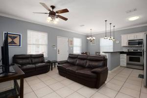 a living room with two leather couches and a kitchen at Luxury 3 Bed 2 Bath 2nd Floor Condo By Beach in South Padre Island