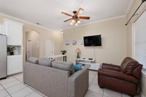 a living room with a couch and a ceiling fan at Luxury 3 Bed 2 Bath 1st Floor Condo Near Beach in South Padre Island