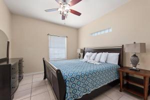 a bedroom with a bed and a ceiling fan at Luxury 3 Bed 2 Bath 1st Floor Condo Near Beach in South Padre Island +14 photos