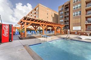 a swimming pool with a pergola next to a building at 1 Bedroom Studio Near Beach w Pool & Amenities in South Padre Island