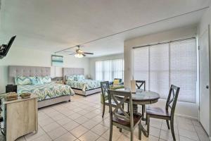 a living room with a bed and a table and chairs at 1 Bedroom Studio Near Beach w Pool & Amenities in South Padre Island