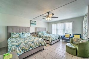 a bedroom with two beds and a ceiling fan at 1 Bedroom Studio Near Beach w Pool & Amenities in South Padre Island +15 photos