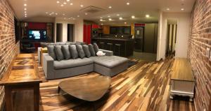 a living room with a couch and a table at Austin Suites Gramado in Gramado