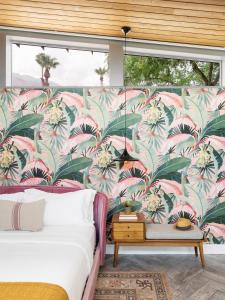 a bedroom with a mural of palm trees at ARRIVE Palm Springs - Adults Only in Palm Springs