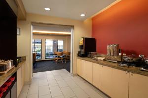 a kitchen with a counter and a dining room at TownePlace Suites Ann Arbor in Ann Arbor