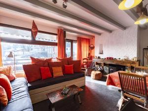 a living room with a couch with red pillows at Appartement Saint-Lary-Soulan, 3 pièces, 6 personnes - FR-1-296-384 in Saint-Lary-Soulan
