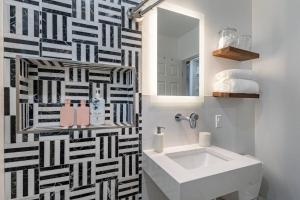 a bathroom with a white sink and a mirror at ASH and KO in Phoenix