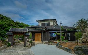 a house with a pathway leading to it at ペットと泊まれる宿一棟貸しkise-㐂瀬- in Amami