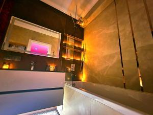 a bathroom with a mirror and a sink in a room at Candle Space in Chişinău +32 photos