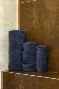 two blue towels sitting on a shelf in a bathroom at Candle Space in Chişinău