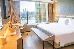 Voodi või voodid majutusasutuse YOHO Treasure Island Hotel toas