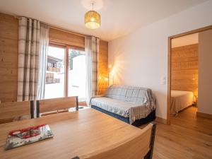 a living room with a bed and a mirror at Appartement Valmorel, 2 pièces, 4 personnes - FR-1-356-413 in Valmorel