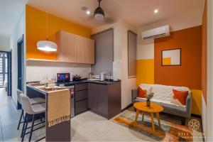 una cucina con divano e tavolo in una camera di Neu Suites Residence KLCC, Five Senses a Kuala Lumpur