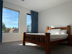 a bedroom with a bed and a large window at New 2-story house with 4 bedrooms and 3 shower rooms in Burwood