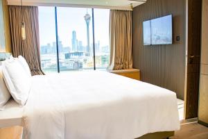 Voodi või voodid majutusasutuse YOHO Treasure Island Hotel toas