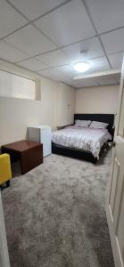 a bedroom with a bed and a desk in it at Home in Winnipeg