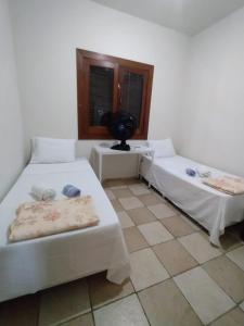 Uma cama ou camas num quarto em Recanto Pau Brasil