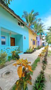 a house with a bunch of plants in front of it at In Dai Aquasports and Beach Resort in Bantayan Island