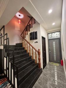 a staircase in a house with aoyer with a door at Jing Cheng Homestay in Jincheng