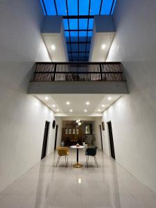 a hallway with a table and chairs and a skylight at Jing Cheng Homestay in Jincheng