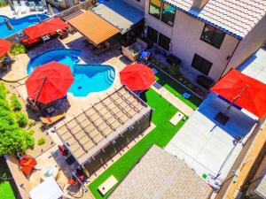 an overhead view of a pool with red umbrellas at Family Home Vacation Retreat Glendale AZ in Phoenix