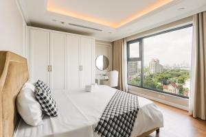 a bedroom with a bed and a large window at D'LEROI SOLEIL- TAY HO- NEAR WESTLAKE IN HA Noi in Hanoi